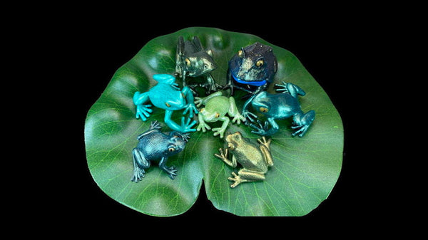 six frog models in shades of metallic green