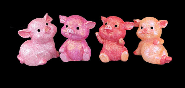 four pig models in shades of pink