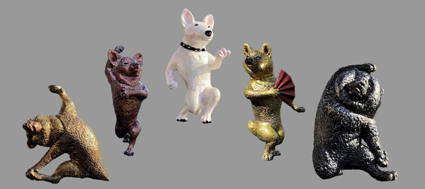 five dog figures dancing in white, black, and brown