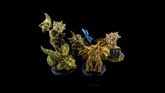 five dragon models in shades of gold