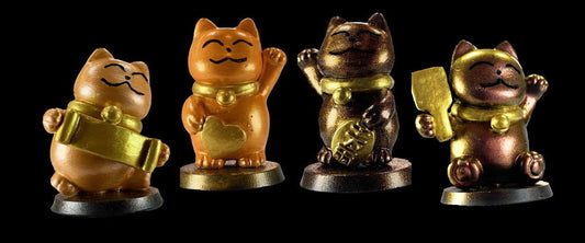 four lucky cats in shades of orange