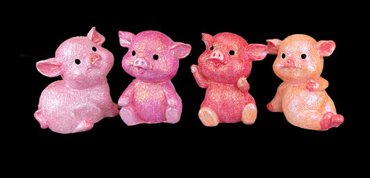 four pig models in shades of pink